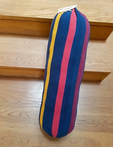 blue lambswool iyengar yoga bolster on wood floor