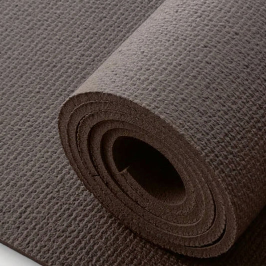 A close-up of a rolled exercise or yoga mat in a dark brown color, showing its textured surface and layered construction.