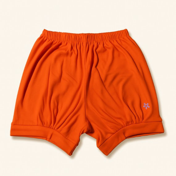 Orange iyengar shorts on a beige background