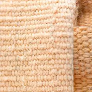organic cotton bolster texture close up orange fabric