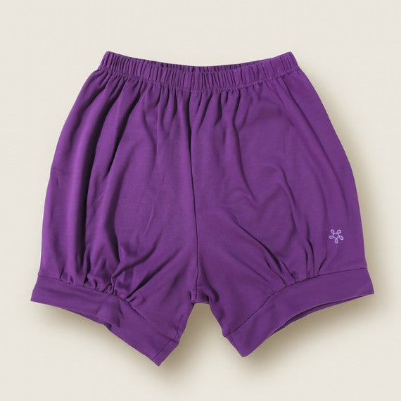 Purple pune shorts on a beige background