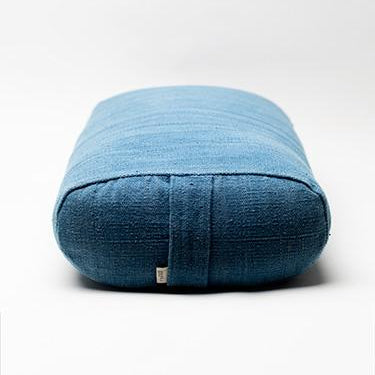 Blue textured yoga cushion on a white background