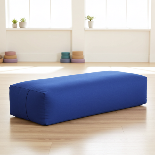 Blue iyengar yoga bolster in a yoga studio on wood floor