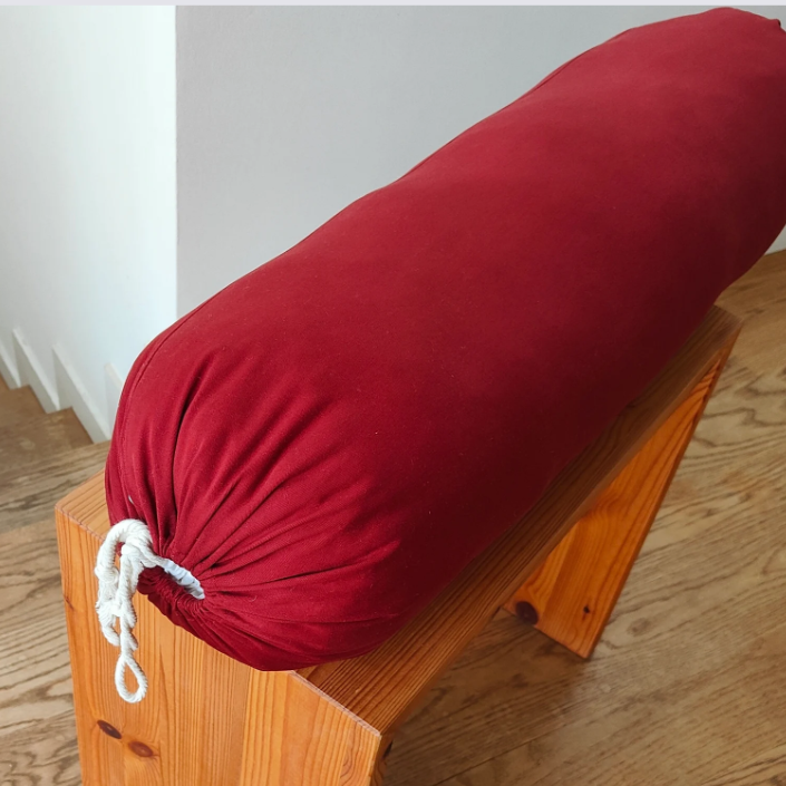 red yoga bolster on halasana box