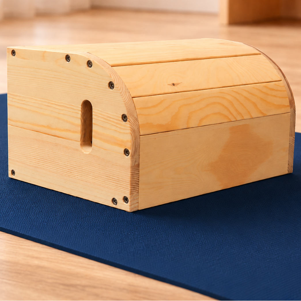 wood viparita karani box yoga prop on a blue mat