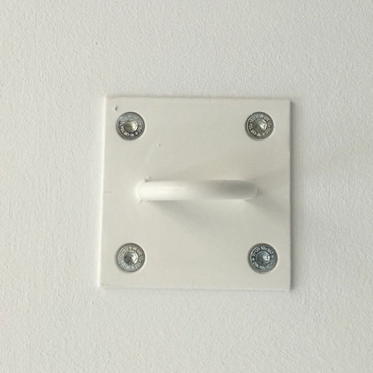A white wall-mounted hook with a square backplate secured by four silver screws, shown against a plain white textured wall.
