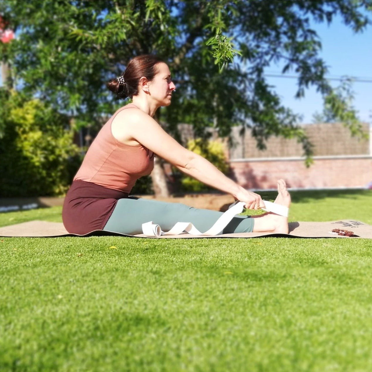paschimottanasana with yoga strap